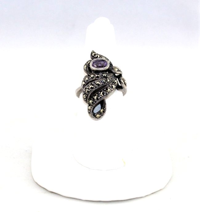 Amethyst Marcasite Sterling Silver RIng Size 6: Amethyst Marcasite Sterling Silver Ring Size 6, measures 1 1/8" high. The front marcasite amethyst part of the ring is 3/4" wide. It weights 5.7 grams. The amethyst is 5.25 mm by 3.25 mm.