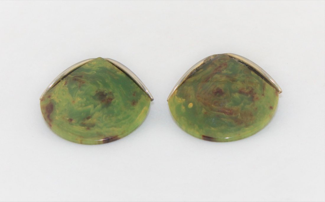 Bakelite Earrings: This is a pair of mottled green Bakelite clip on earrings. They are 1" high and 1 1/2" wide. They are in good working order, but the original gold tone metal has faded to silver.