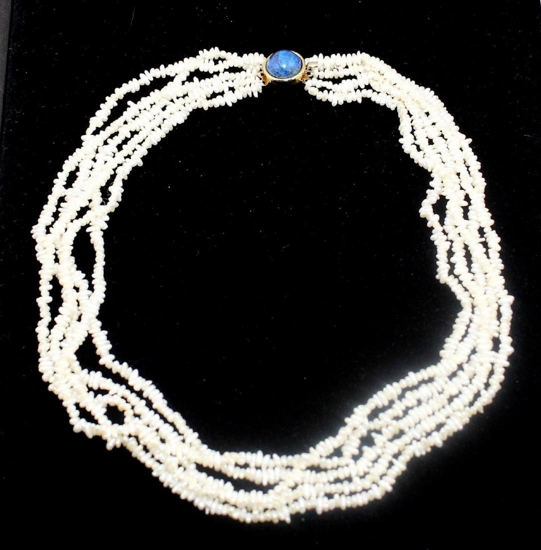 5 Strand Fresh Water Pearl Necklace Lapis Lazuli Clasp: 5 Strand White Fresh Water Pearl Necklace Gold on Sterling Silver Lapis Clasp. Marked: Marked Silver on back of clasp, tests positive for sterling silver. Materials: Fresh water pearls, lapis lazuli &