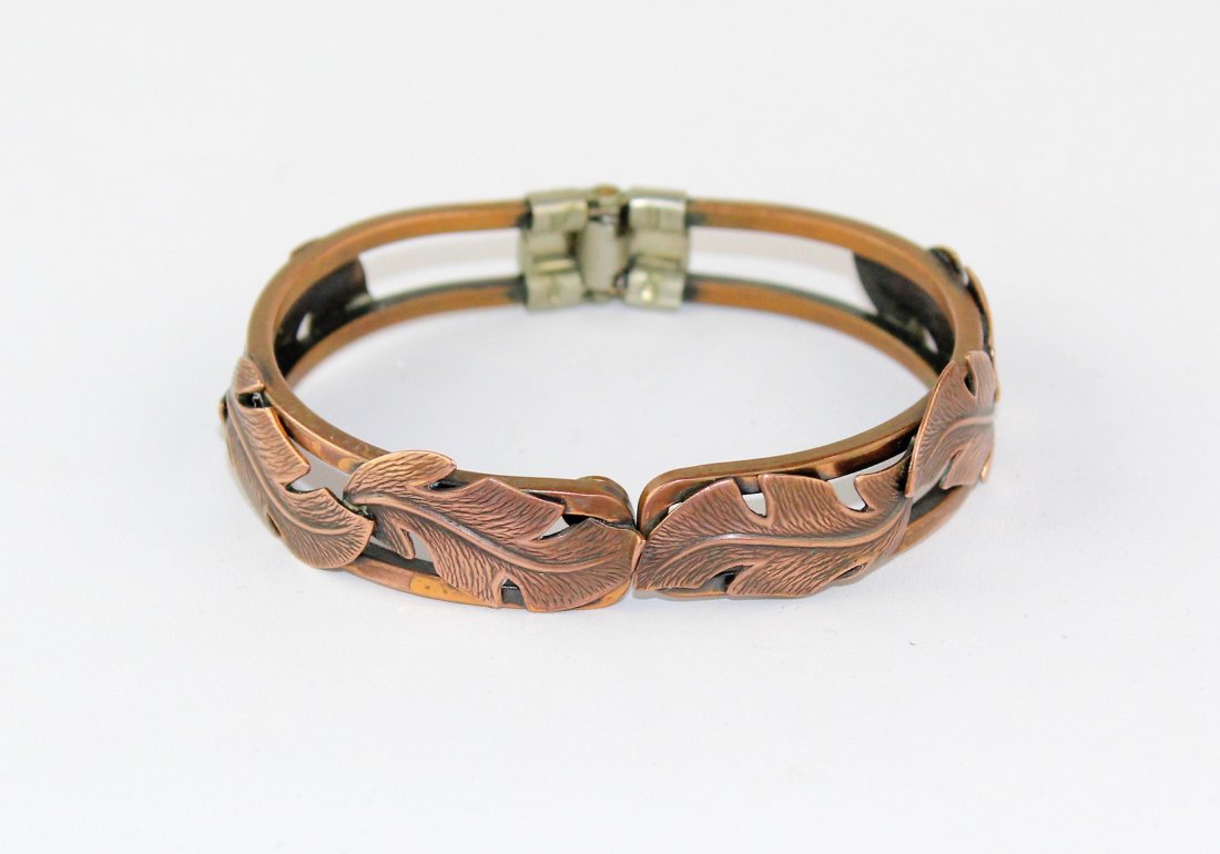 Copper by Bell Hinged Copper Hinged Bangle Bracelet: Beautiful hinged copper bangle bracelet marked Copper by Bell, made by Native American Navajo Indians, sold in Albuquerque New Mexico, from 1932 until 1969. The interior length is 6 1/2" and 3/4" wide