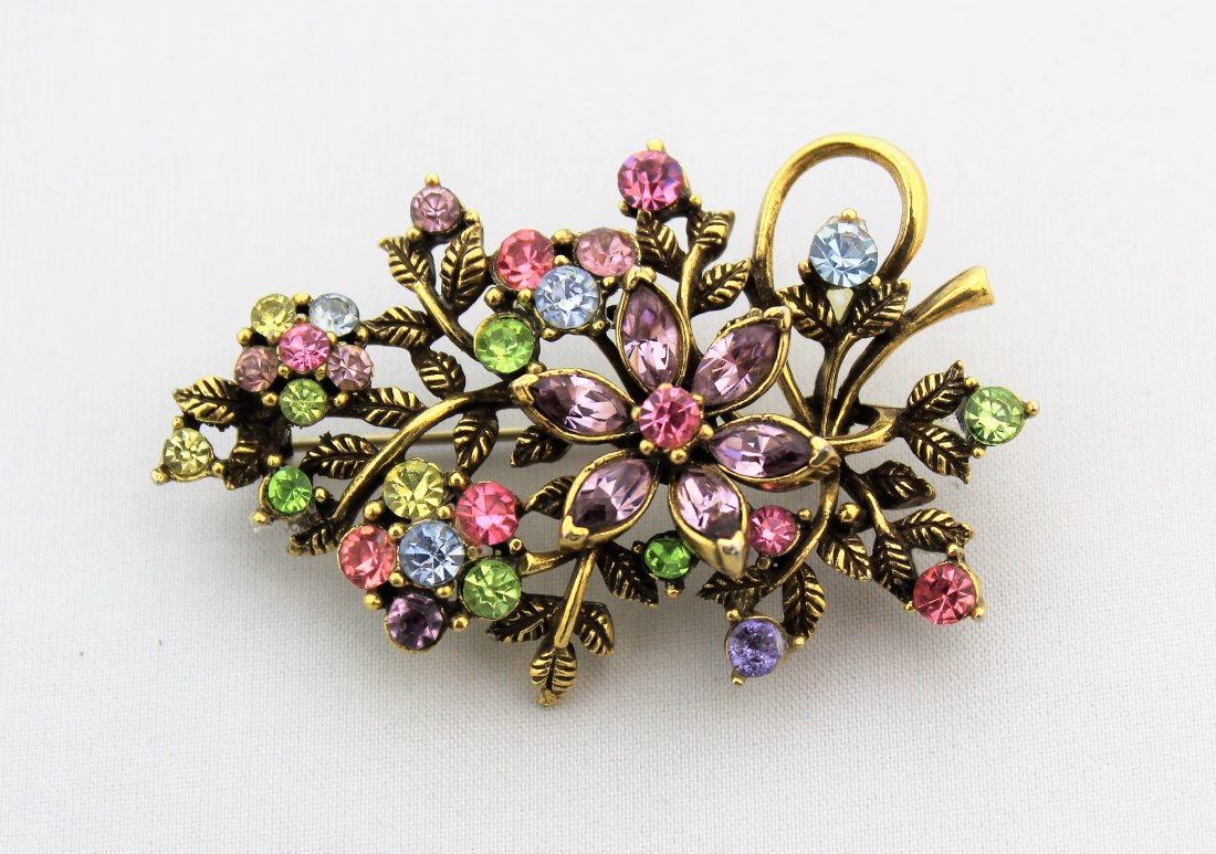CORO Pastel Rhinestone Floral Brooch: CORO Pastel Rhinestone Floral Brooch measures 2 1/2" wide and 1 1/2" high in blue, pink, yellow and purple pastel rhinestones and an antiqued gold metal setting.