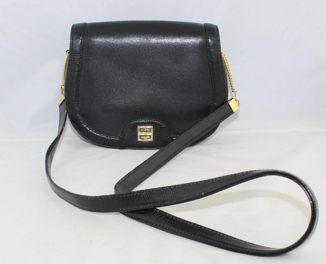 Vintage Givenchy Black Leather Shoulder Bag: Beautiful vintage designer shoulder bag by Givenchy in black leather. The bag is a petite size, measuring 6" high, 7 1/2" wide and 2 1/2" deep. The shoulder strap is 34" long.