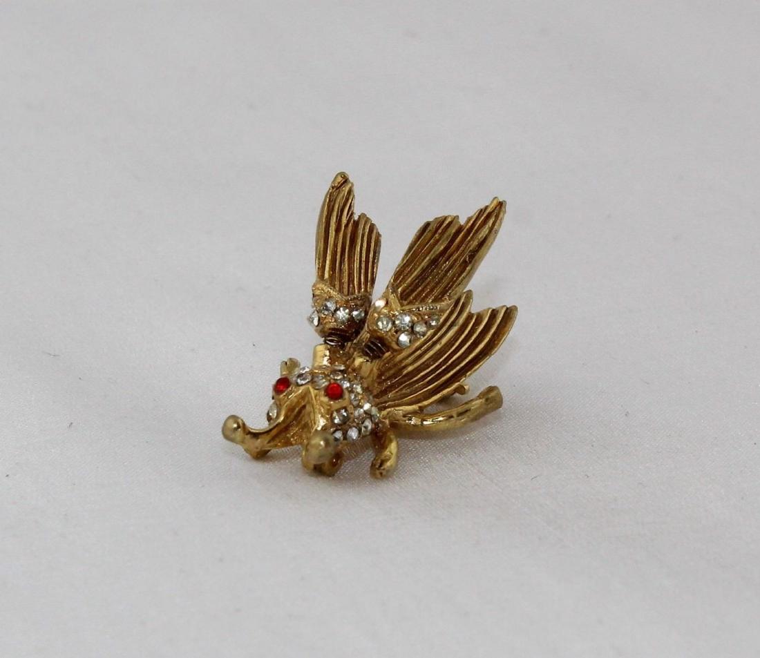 HATTIE CARNEGIE Rhinestone Gold Tone Trembler Brooch: Vintage HATTIE CARNEGIE Signed Rhinestone Gold Tone Trembler Fly Pin Brooch. Color: Gold, Red, White or clear. Brand: Hattie Carnegie. Measurements: Width: 1 1/2", Height: 1", Depth: 1".