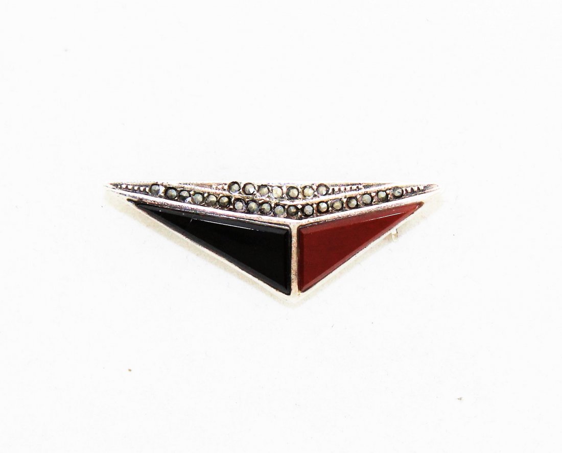 Sterling Silver Marcasite Onyx Carnelian Deco Pin: Beautiful sterling silver pin, marked 925. The front has inlaid black onyx, orange carnelian and marcasite stones in an Art Deco design. Great condition. It is 1 1/2" wide and 1/2 an inch high.