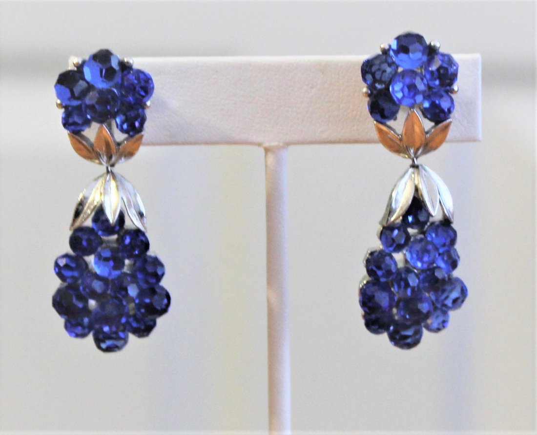 Vintage Trifari Blue Rhinestone Earrings: Vintage Crown Trifari Blue Rhinestone Dangling Clip On Earrings are marked on the back of the clip with the word Trifari and a crown above it. The length is 2" and width is 3/4".
