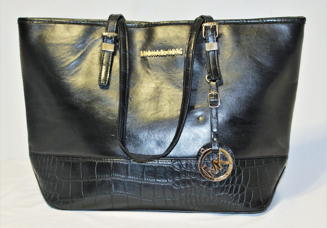 Michael Kors XL Black Bag: Beautiful Black Over sized Tote or Shoulder Bag, made by Michael Kors. The bag is made of PVC, but looks exactly like leather. The interior is lined with a striped fabric and has 3 interior pockets, o