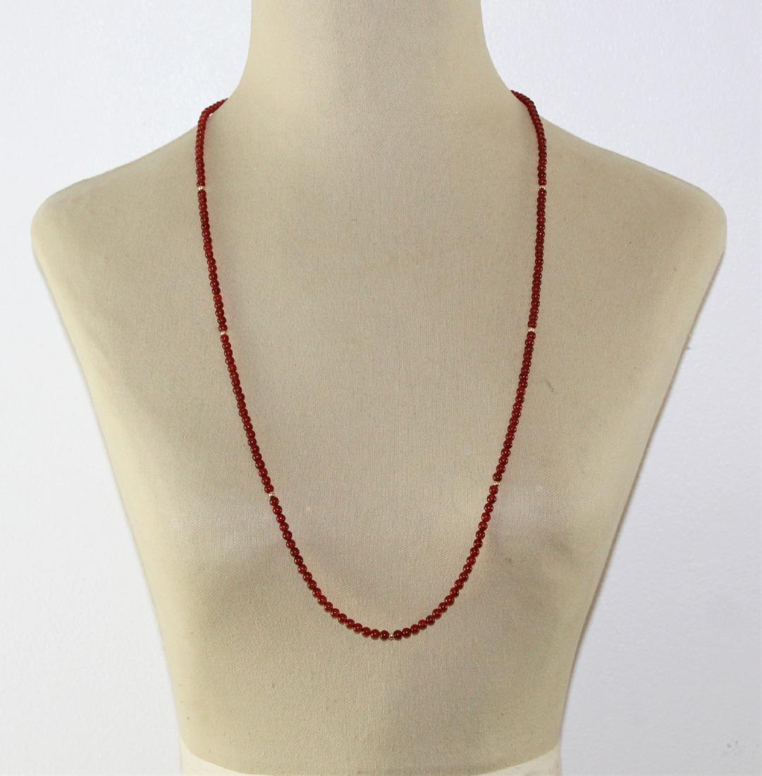 Vintage Carnelian Bead Necklace: 34" Vintage Red Carnelian Bead Necklace has 4 mm beads that has a gold tone bead between every 20 carnelian beads.