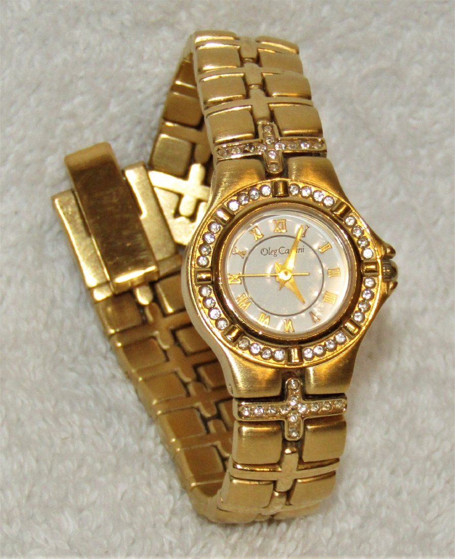 OLEG CASSINI Women's Rhinestone Bezel Gold Tone Watch: OLEG CASSINI Women's Rhinestone Bezel Gold Tone Watch - It Works. Measurements: Width: 1 1/4" (watch), 1/2" (band), Length: 6 1/2" (clasped), Condition: Very good condition, it works & has a new batte