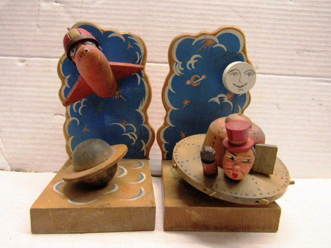 Anri Italy Space bookends SCARCE: Wooden space related bookends by Anri, Italy. One has original paper label on back. There is a spaceship flying saucer, astronauts, planets, nice and unusual. Hand painted
