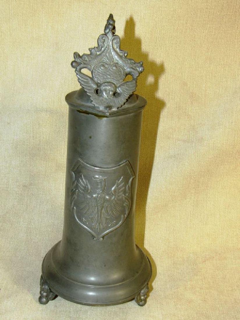 Antique German pewter beer stein: Antique German pewter beer stein Phoenix Firebird on shield. Footed stein stands 11.5" tall, has a hinged lid with a winged griffen, front of lid has a winged cherub and a pair of dolphins.