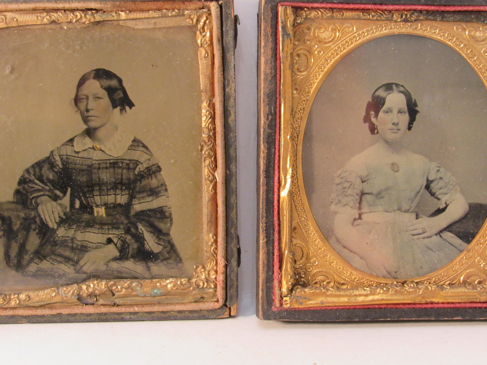 2 antique daguerrotypes: Two young women, 3" x 3-1/2", earrings, ring, pendants, and belt buckle painted gold, cheeks are colored rosy. The frilly dress is colored light blue.