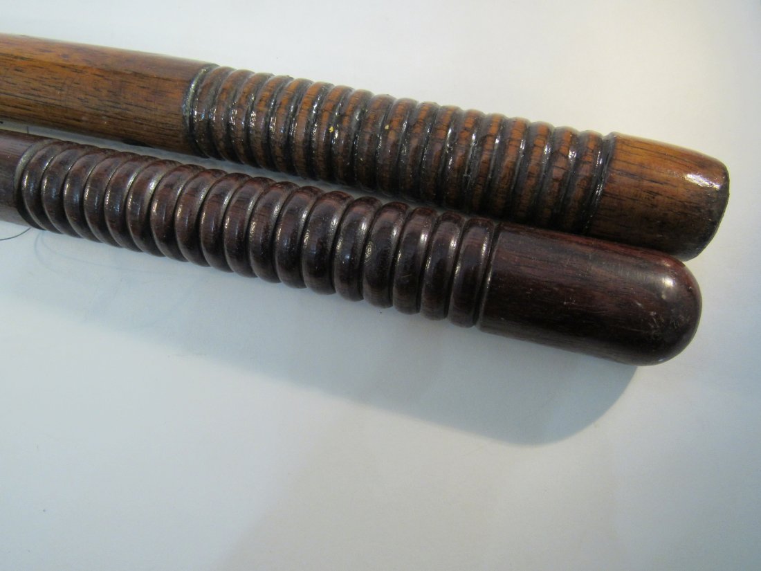 2 Viintage wood police batons, nightsticks, billy clubs: 1-24" solid oak, 1-22.5" rosewood, both are 1" in diameter with ribbed grips.