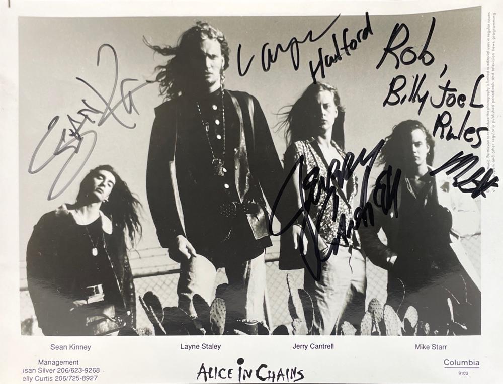 Alice in Chains: Group Signed 8" x 10" Press Photo (Beckett/BAS Guaranteed): This 8" x 10" Press Photo has been signed by Sean Kinney, Layne Staley, Jerry Cantrell, and Mike Starr of Alice in Chains. Please see photos for condition as there minor adhesive and paper loss on the