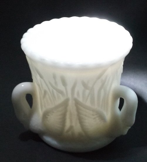 Three Swan Handled Milk Glass Cup 1949-84 Westmoreland: Three swan handled milk glass cup, the hallmark design of the Westmoreland Glass Company, the mark on the bottom of the cup was in use 1949-1984. The Westmoreland Glass Company is known for its produc