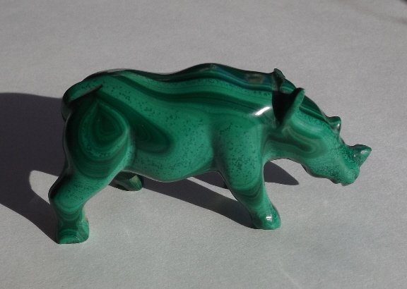 Hand Carved Malachite Miniature Figurine Rhinoceros: Hand carved out of one solid piece of malachite miniature rhinoceros. Malachite, known as the "stone of transformation" is believed to assist one in situations of change, to clarify emotions, to relea