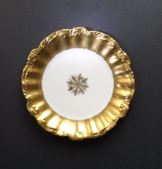 Strauss & Son Limoges Side Gold Plate, France 1900s: Limoges antique porcelain medallion side plate that date back to the late 19th or very early 20th century. This antique porcelain plate has fluted rim with a lovely molded filigree pattern on the oute