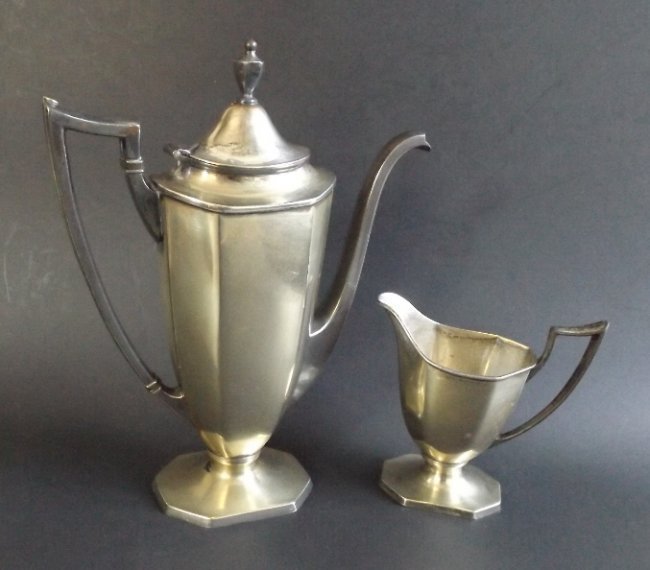 Art Deco Stream Line coffee pot and creamer 1920s Homan: Antique Art Deco set Stream Line coffee / tea pot and creamer; slightly yellowish body, silvery with black patina handles. The set was produced by the Homan Manufacturing Company, USA, 1920s. Marked a