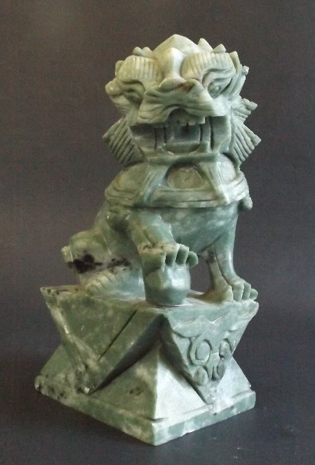 Foo Dog Imperial Guardian Lion figure hand carved China: Original greenish jadeite-color soapstone figurine, Chinese male Foo Dog holding a globe under his right paw, or Imperial Guardian Lion, is a strong feng shui protection symbol. Foo Dogs were traditio