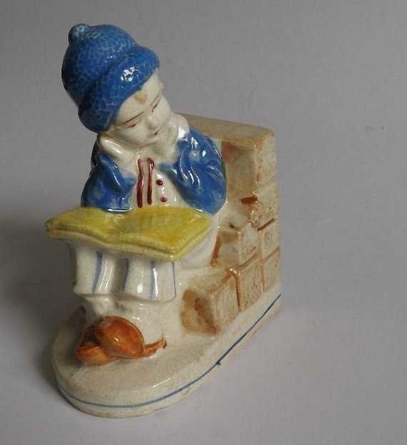 Dutch Boy figurine, Porcelain Bookend, 1940s Japan: Mid Century bookend, Dutch boy reading a book, hand painted porcelain filled with heavy material, probably plaster, marked on the bottom "KKS 560" [1940s-50s Japan]; nice craquelure glaze. Rates vary 
