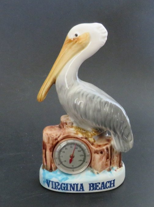 Porcelain Pelican Figurine with Thermometer 1950s: Vintage Mid Century Modern porcelain bird pelican figurine with thermometer -- long billed pelican perched on wood pilings in water; working Fahrenheit and Celsius thermometer embedded in front, Virgi