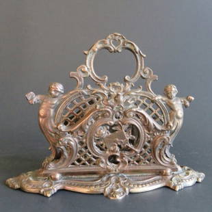 Antique Brass Letter Holder Bradley & Hubbard 1880s, signed, numbered: Antique two-division Victorian brass letter holder with pierced and embossed decoration and cherubs on the sides, 1880s-1890s. The cast into mold Bradley & Hubbard five-sided triangle and lantern mark