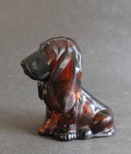 Vintage Avon Dog, Baby Basset Topaze Cologne Bottle, 1970s: Vintage Avon dog "Baby Basset Topaze Cologne" bottle, 1970s, the paper label on bottom is present. The amber / brown topaz glass bottle with matching color plastic head. The figurine-bottle is 3.1/2"