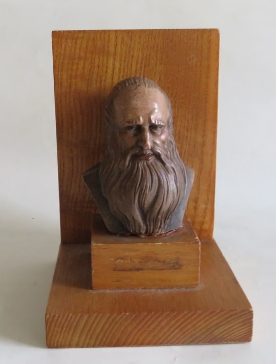 Leonardo Da Vinci Bookend, Toriart, ANRI Italy, 1950s, Mid Century: "Leonardo Da Vinci", Mid Century bookend by Toriart, ANRI, Italy, the original label on the bottom is present, 1950s. Wood & wood composite,the bookend is 6" [15cm] tall; 4" x 3.1/2" [15cm x 9cm]; ver