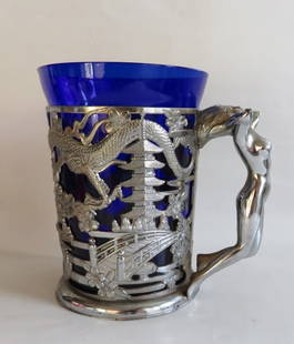 Vintage Japanese Mug, Cobalt Glass with Silvery Cup Holder, 1990s: Vintage mug consisting of metal glass holder and cobalt glass, unmarked, Japan, 1990s. The embossed glass holder shows traditional Asian landscape with pagoda temple, dragons, and mount Fuji / Fujiyam