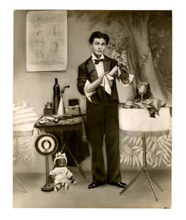 Terrific & early original publicity photo of magician: A publicity photograph of Harry Houdini, taken early in his career, soon before his discovery by Martin Beck Photograph, 8" x 10", black and white image of Houdini, posing full length in a tuxedo befo