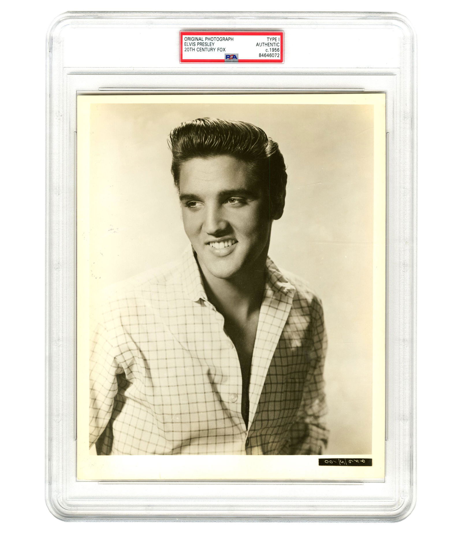 Charming & Handsome Elvis Presley PSA Type I Photo (ca.1956): Charming & Handsome Elvis Presley PSA Type I Photo (ca.1956) Black and white photograph, measuring 8" x 10", n.p., n.d. [ca. 1956]. A smiling Elvis Presley looks off camera while posing for a port