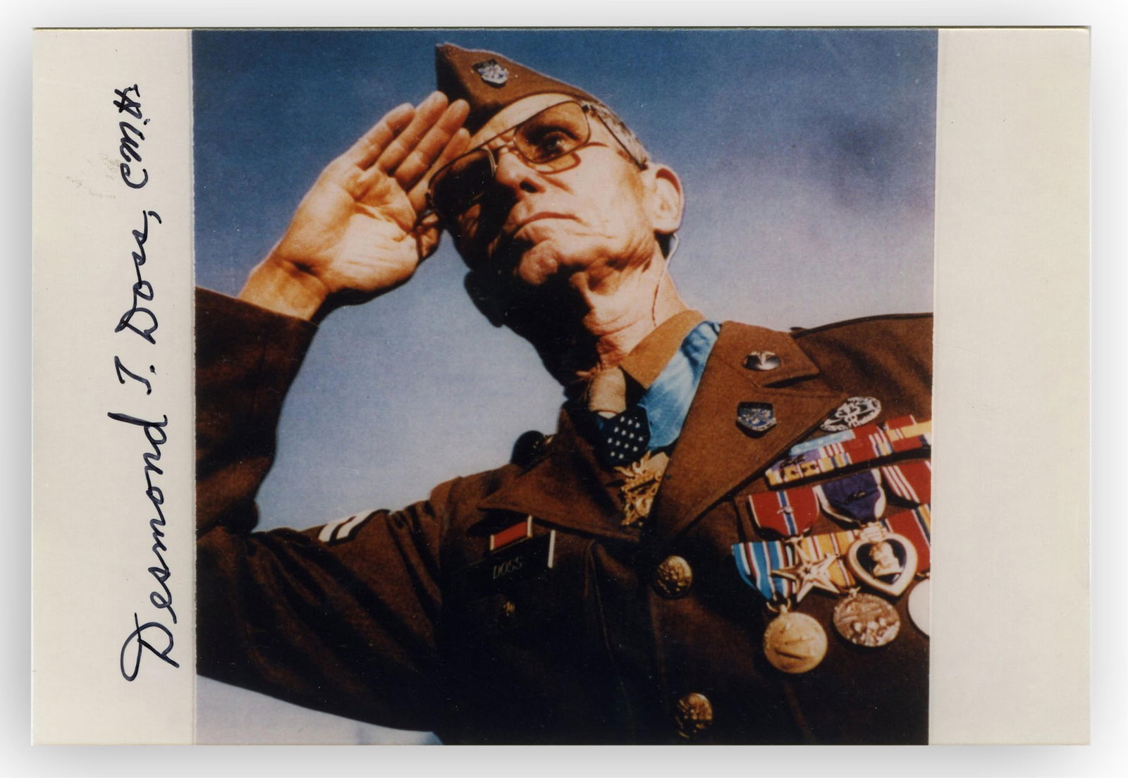 Desmond Doss, Heroic Congressional Medal of Honor Recipient, Conscientious Objector and Combat Medic: Desmond Doss n.p., n.d. Desmond Doss, Heroic Congressional Medal of Honor Recipient, Conscientious Objector and Combat Medic Signed photograph Desmond Doss (1919-2006) Iconic color photo of Corporal