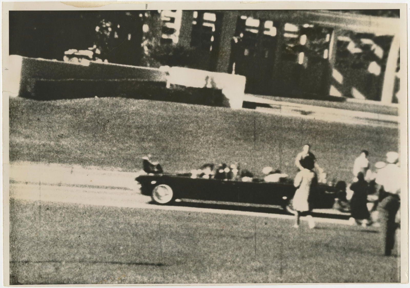 JFK Assassination! Large Photo with PSA LOA, Type IV Taken After the Fact: John F. Kennedyn.p., n.d.JFK Assassination! Large Photo with PSA LOA, Type IV Taken After the FactPhotographBlack and white Type IV photograph of the chaotic moments just after the shot rang out that
