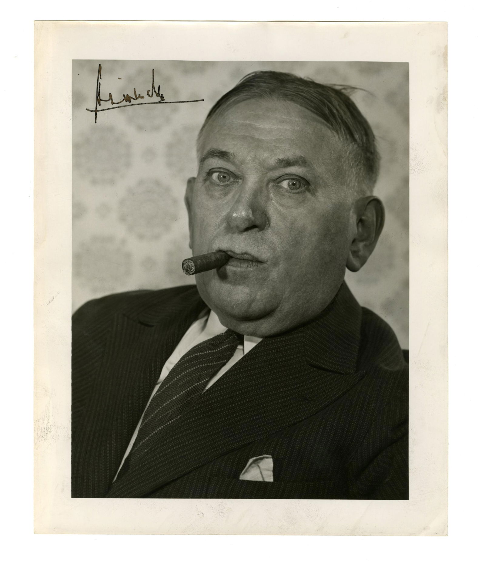 H. L. Mencken Signed Photo by Bodine: Henry L. Menckenn.p., n.d. [ca. 1940]H. L. Mencken Signed Photo by BodineSigned photographA glossy, black and white photographic print of American journalist H. L. Mencken smoking a cigar. 1p, measuri