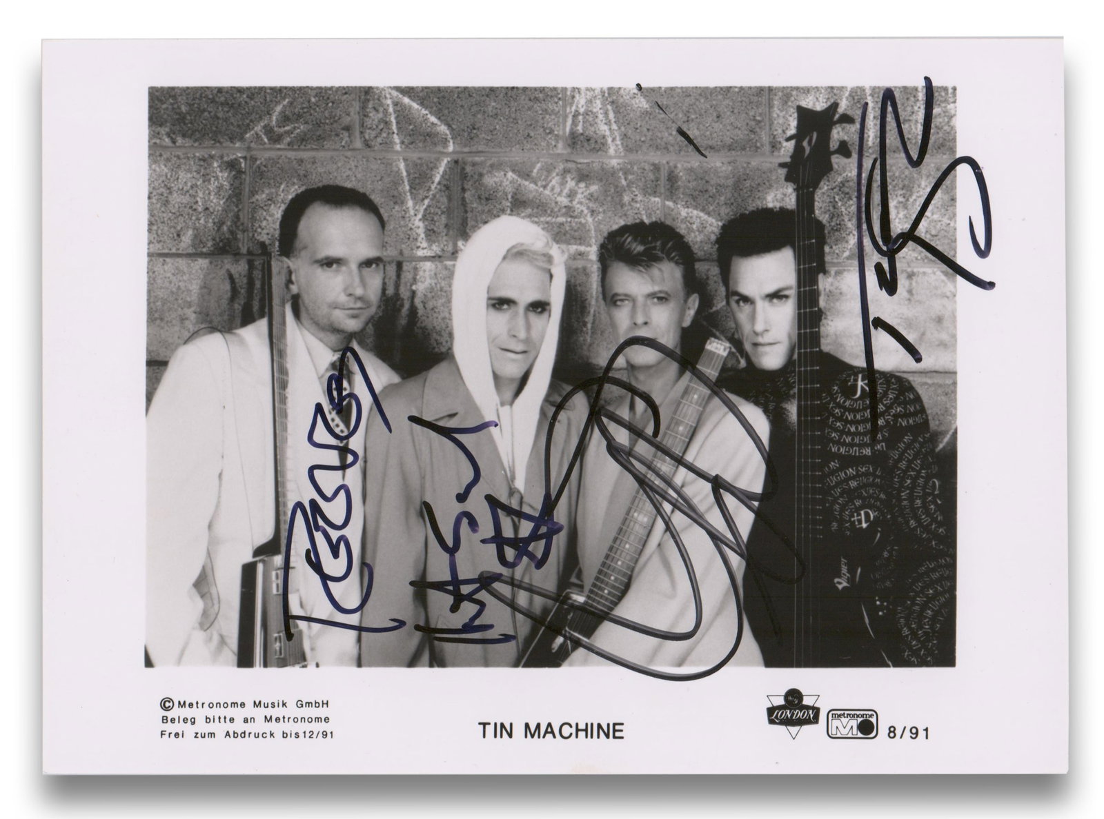 Tin Machine Group Signed Photo: Bowie, Gabrels & Sales Brothers: Tin Machine [Hamburg, Germany], ca. 1991 Tin Machine Group Signed Photo: Bowie, Gabrels & Sales Brothers Signed photograph A glossy, black and white publicity photo of the rock band Tin Machine, produ