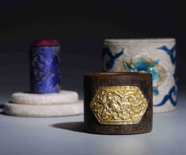 AGARWOOD TRIGGER FINGER RING WITH GOLD FLOWER INCLAID: Agarwood Trigger Finger Ring With Gold Flower Inclaid. Height: 3.1cm Inner Diameter: 2.2cm Weight: 27g