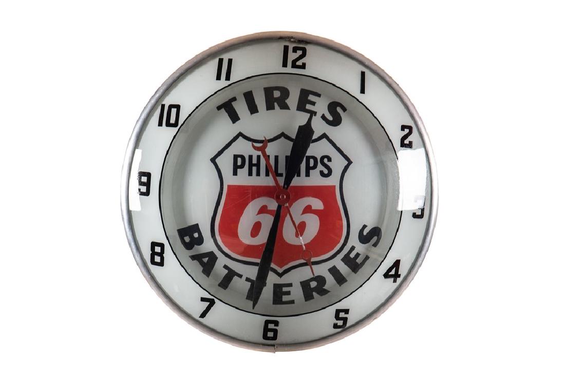 Phillips 66 Tires & Batteries Double Bubble Clock: Phillips 66 Tires & Batteries Double Bubble Clock The clock has good color. It shows a few minor flaws on the outer lens and the interior lens lens is very clean. The second hand shows areas of paint