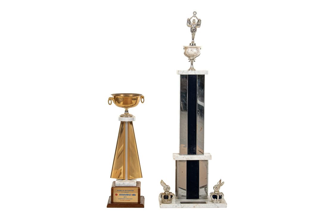 2 NHRA 1971 Winter Nationals & Cordova Trophies: 1971 Winter Nationals class winner trophy and a World Series of Drag Racing Cordova trophy. Both are complete and in good shape. Both show areas of wear and flaws in the finish. Overall they display n