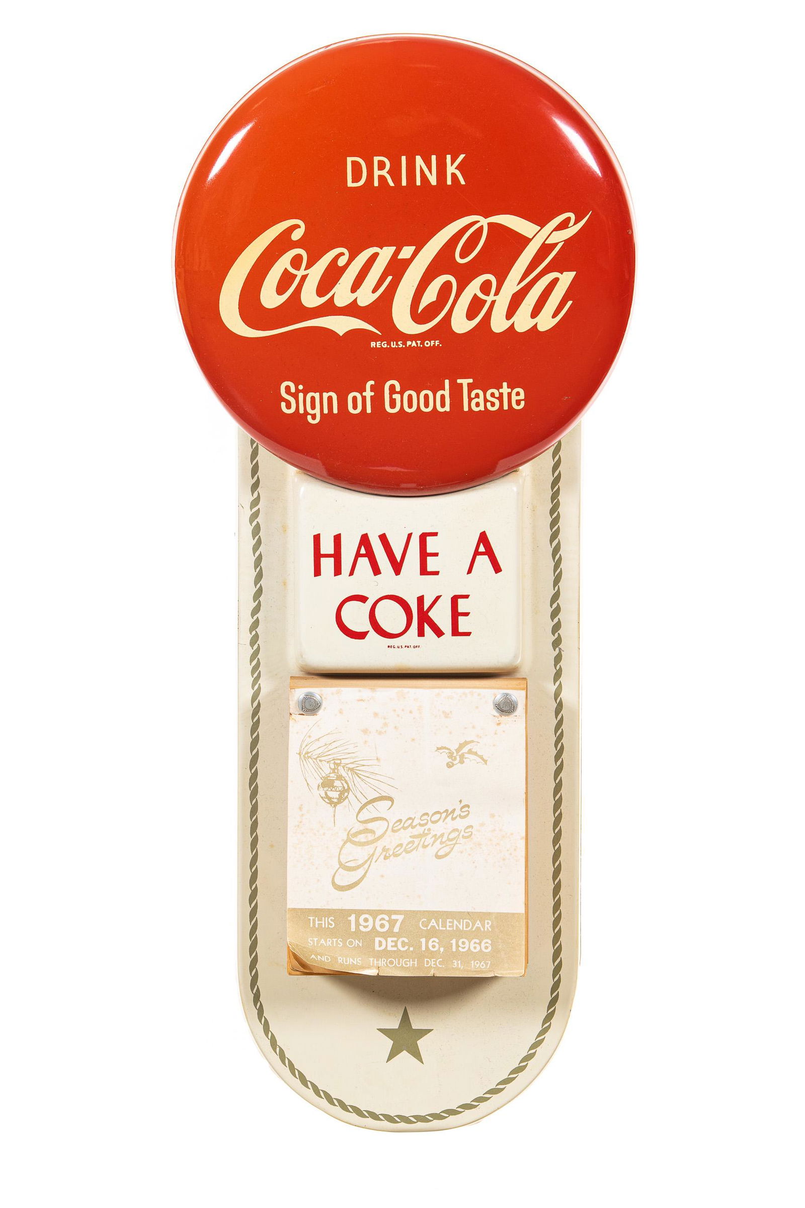 1967 Coca Cola Have A Coke Calendar Sign: SST. It has good color and gloss. It shows light wear, slight discoloration, minor paint loss, and small flaws throughout. The paper of the calendar shows some minor damage. It displays well. Measures