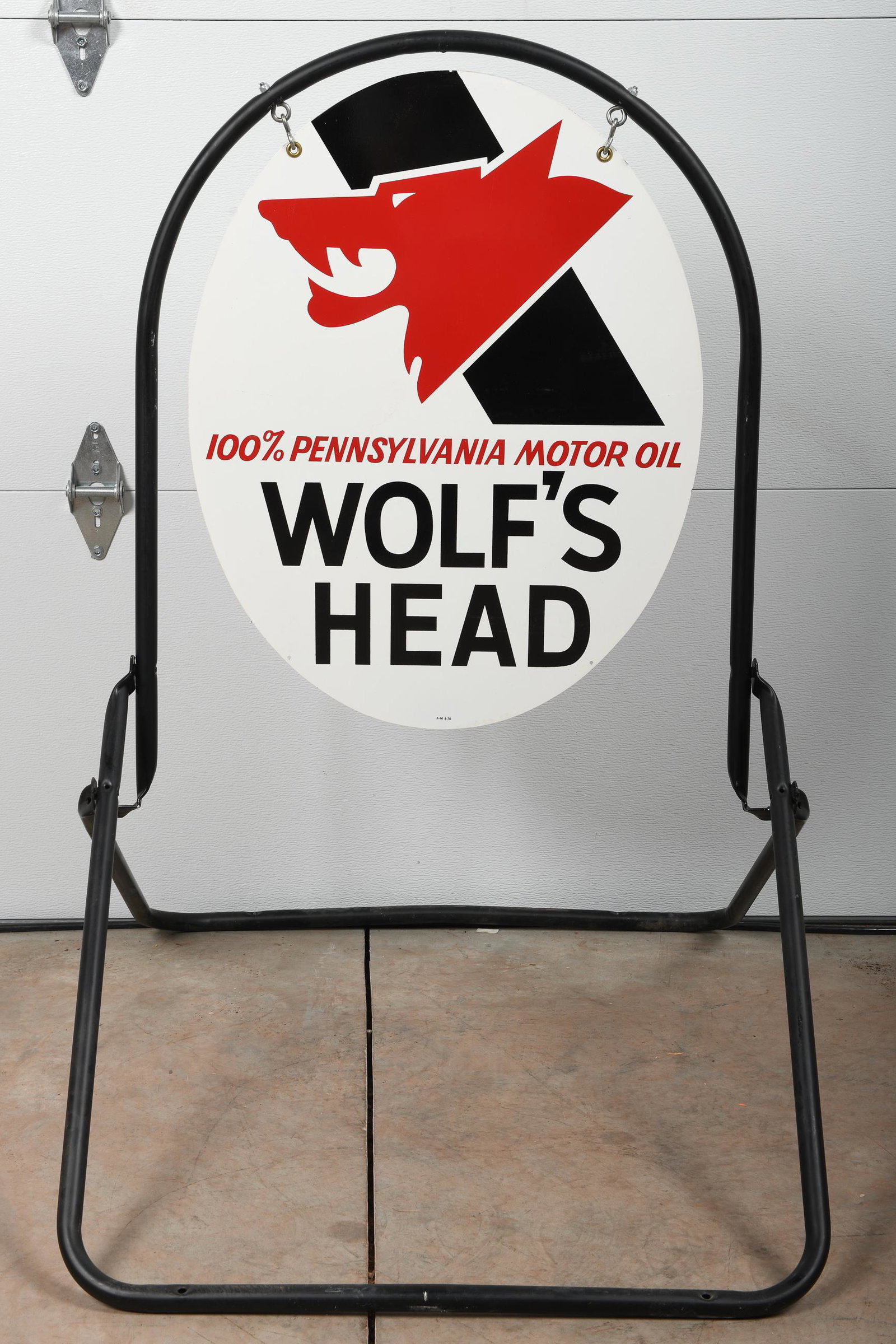 NOS Wolf's Head Motor Oil Curb Sign: DST in original stand. Measures: 48"X31" Rating: 8.5 Est: $400-$700