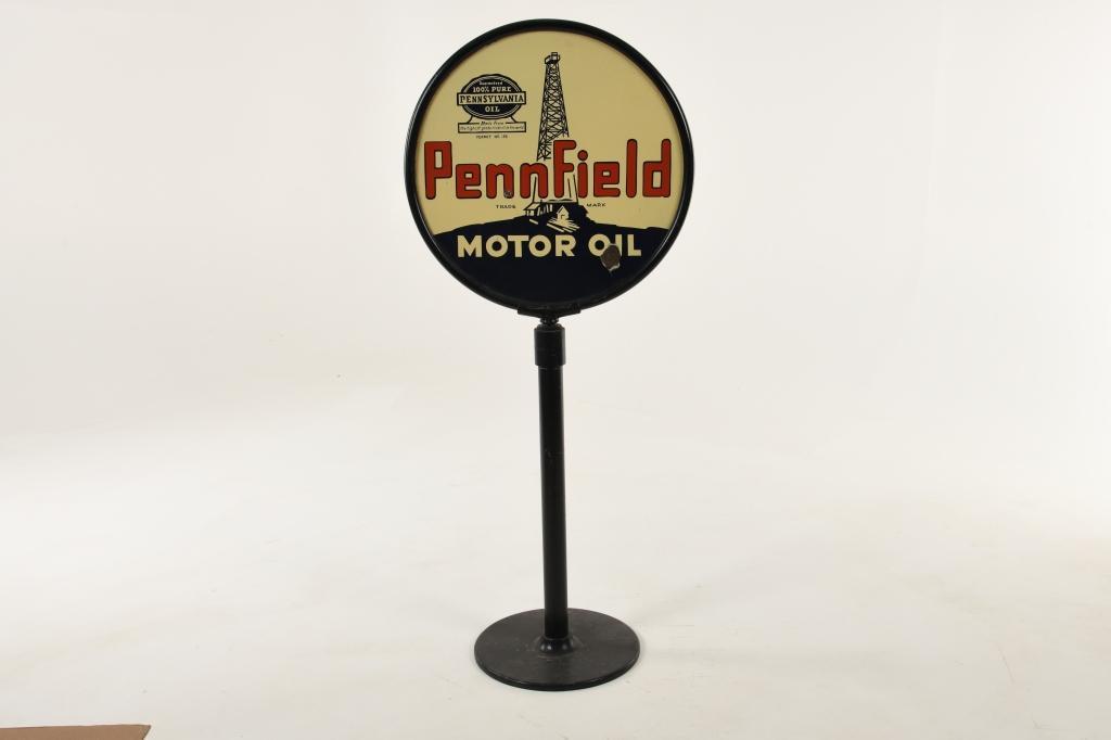 Pennfield Motor Oil Curb Sign: DSP. It has good color and gloss. It shows light wear, flaws, areas of slight discoloration, and some chipping throughout. The frame, pole, and base have been repainted. It displays well. Measures: 62