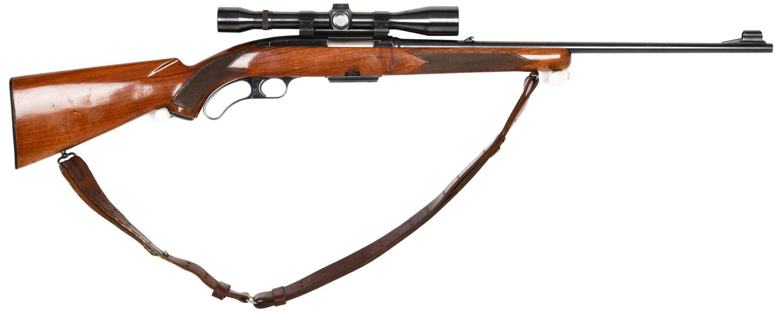 Winchester Model 88 .308 Caliber Lever Action Rifle: Comes with a scope. Stock shows carry wear. Fold down rear sight. Comes with one magazine. 80% blue. Built 1958