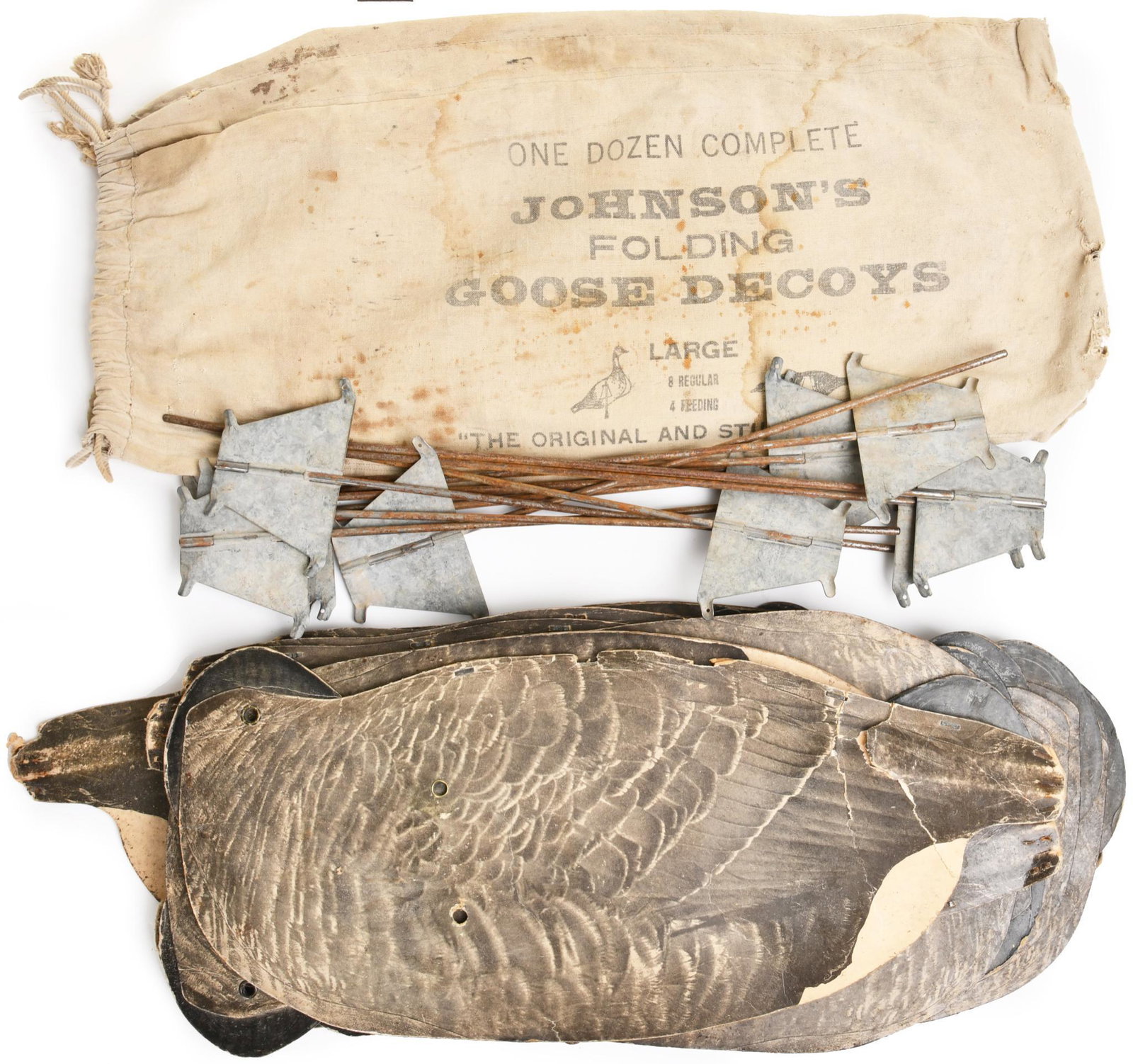 12 Johnson"s Folding Goose Decoys: 12 folding decoys in original bag. Wax coated cardboard. All have wear throughout. Nice complete set. 12"X24" Fair condition.