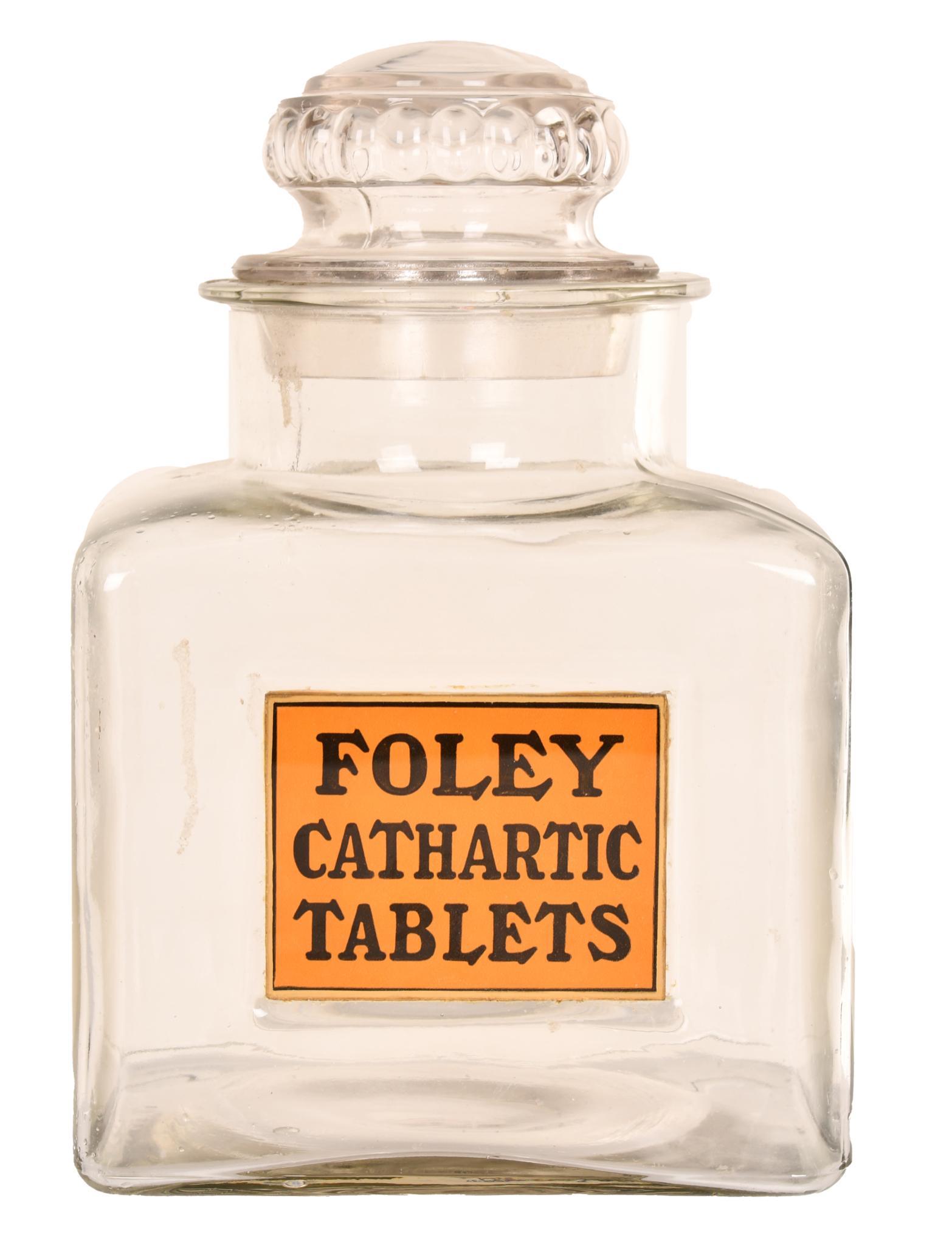 Foley Cathartic Tablets Press Glass Counter-Top Display: Has an applied reverse glass label, I do not think it is the original lid, glass jar has no breaks, cracks or repairs, 10.5" tall. Excellent condition.