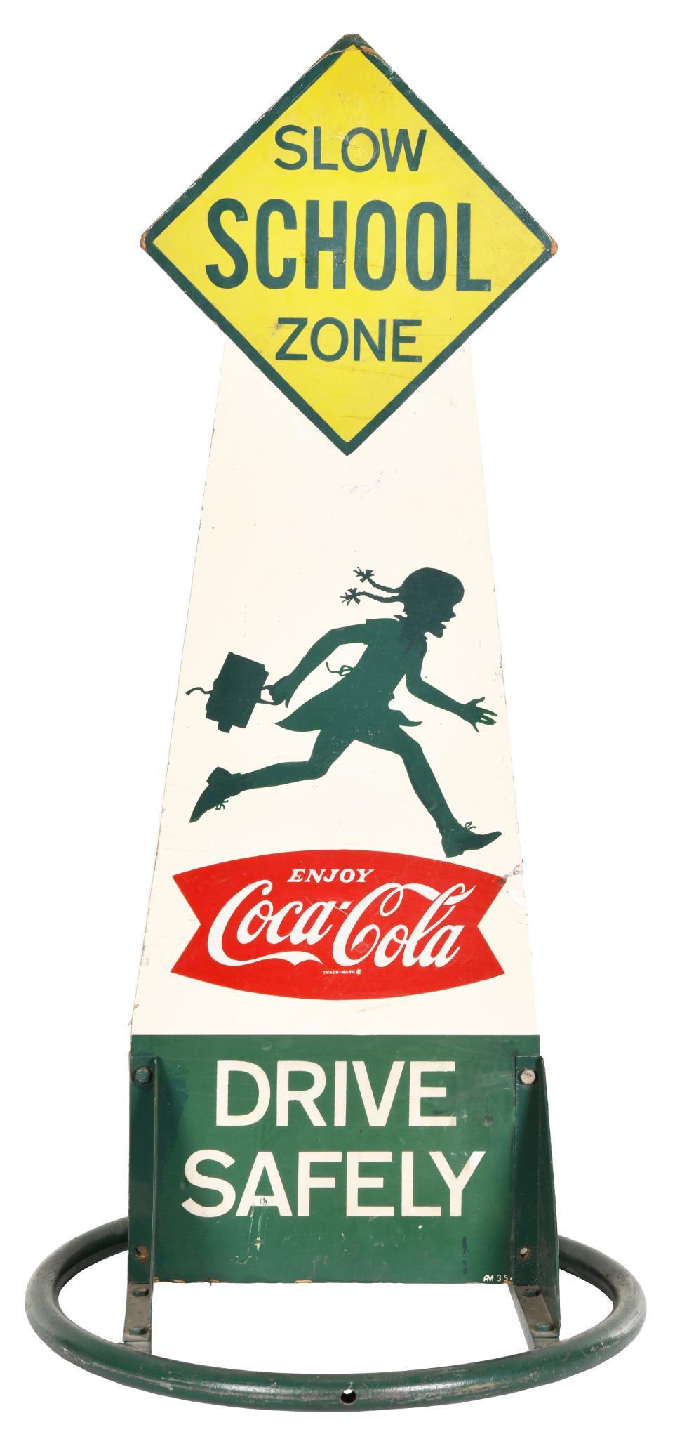 Coca-Cola w/Fish Tail Logo "Slow School Zone" Sign: Double-sided wood sign, has good color, has girl on one side and Coke bottle on the other, shows light wear and a few fine scratches, mounted on a round metal base, 50"x20"x20", rated 8.25