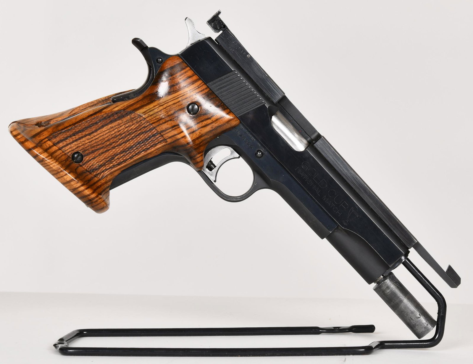 Colt Gold Cup National Match 45 ACP custom target: Very good condition gun with what appear to be Sanderson grips. the weight out front is home made. Has a colt factory barrel. comes with one colt 7 round mag.