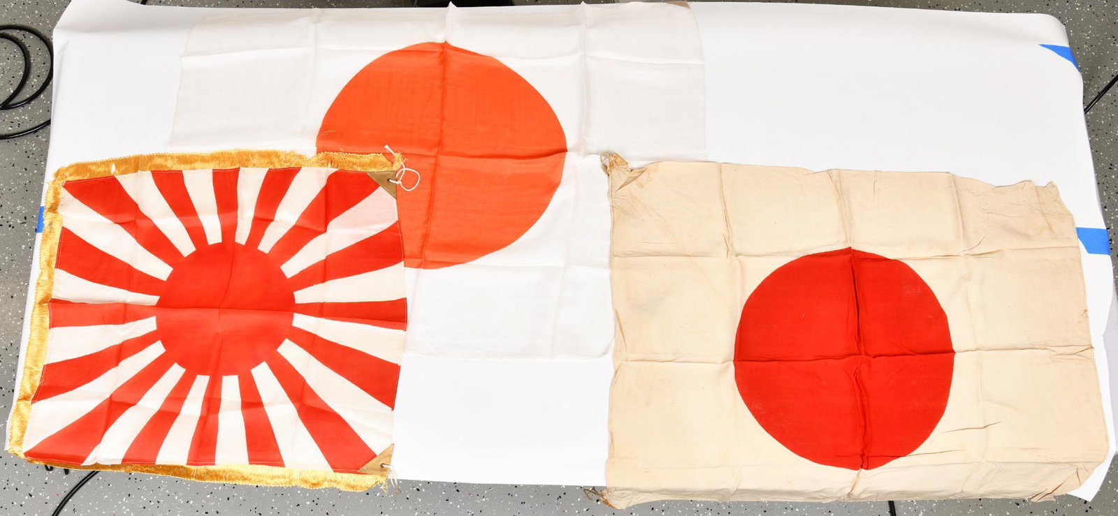 Lot Of 3 Japanese Flags: All three have good color. One shows heavier discoloration. 27"X37"/26"X32/22"X24" Nice lot of Jap flags.