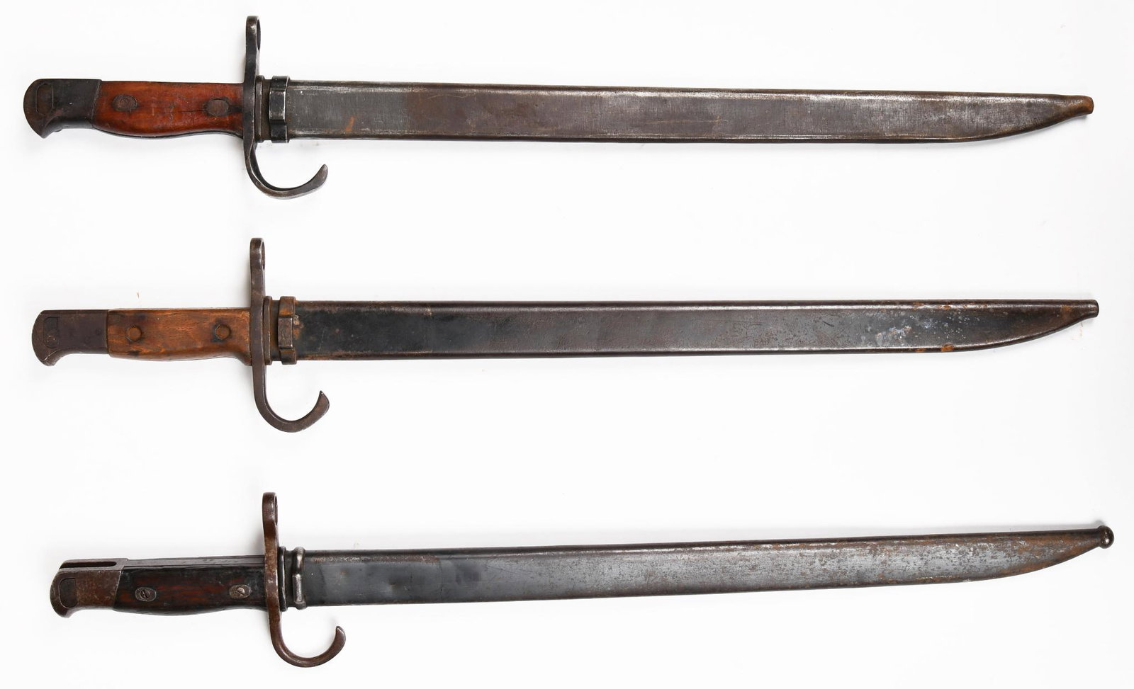 Lot of 3 WWII Japanese Type 38 Arisaka Bayonets: 16" blades. Two have Tokyo Arsenal marks and the third is not marked. Shows wear and paint loss throughout.