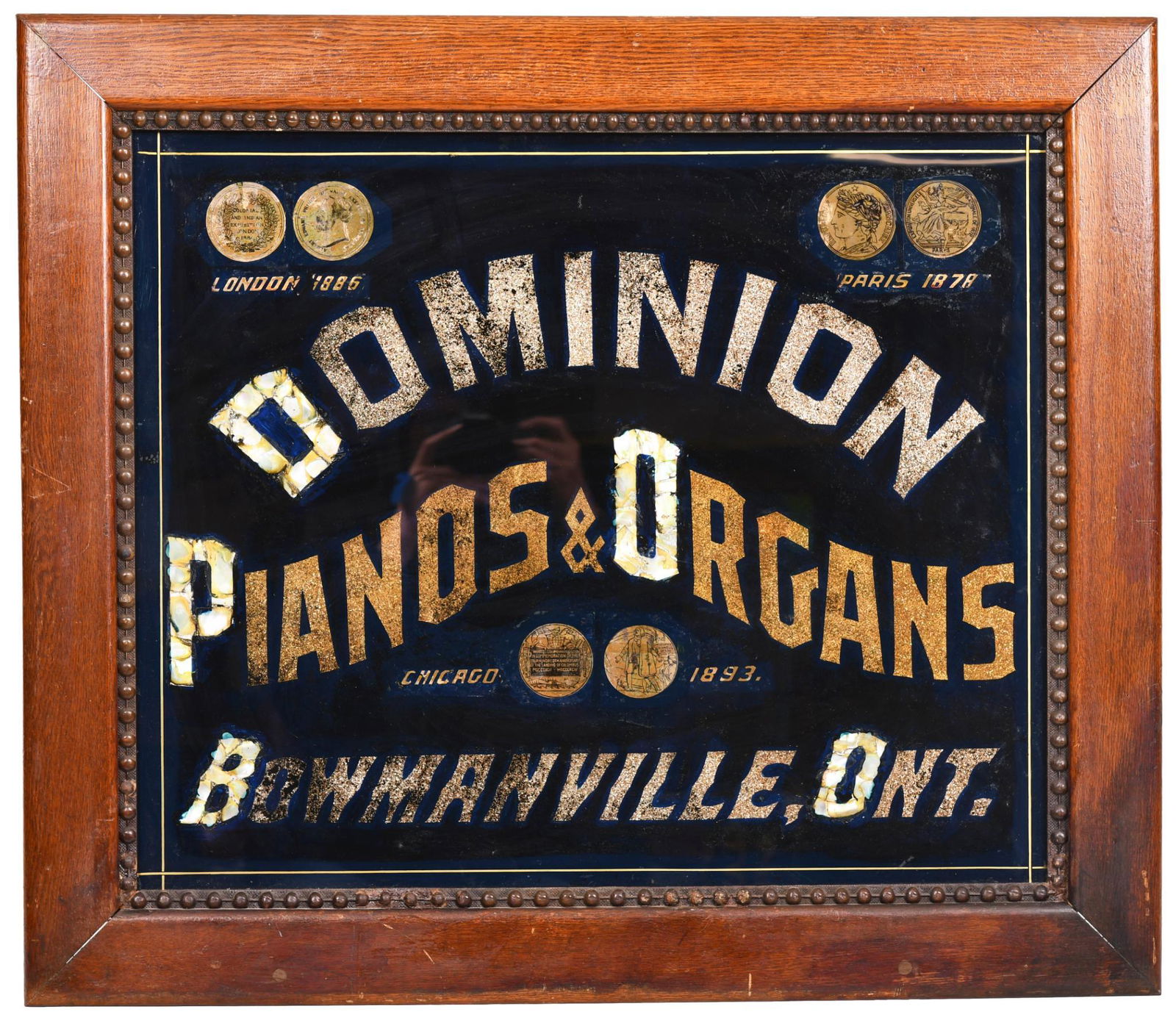 Dominion Pianos & Organs Reverse Painted on Glass: In a nice oak frame, has some touched up areas, displays well, shows some wear, 26"x30", rated 7.5