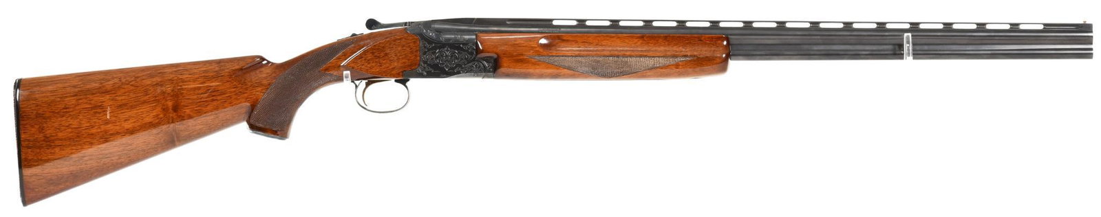 Winchester 101 .410 Gauge Over-and-under Shotgun: 26.5" vent rib barrel. I/C and MOD choked barrels. Very good used condition, with bright bores and ejectors. SST. Couple of handling marks in the stock. 99% blue.
