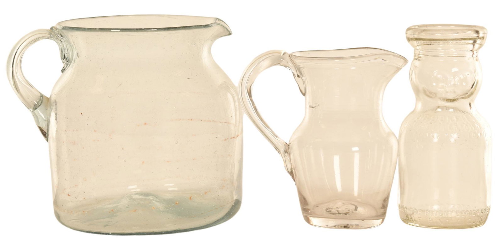 Lot Of 3 Pitchers & Milk Bottle: The two pitchers are nice with no chips and rough pontil marks, the milk bottle has a face at the top and is marked Brookfield Dairy Hellertown, PA., they display well, 5.5" tall or less, rated 9+
